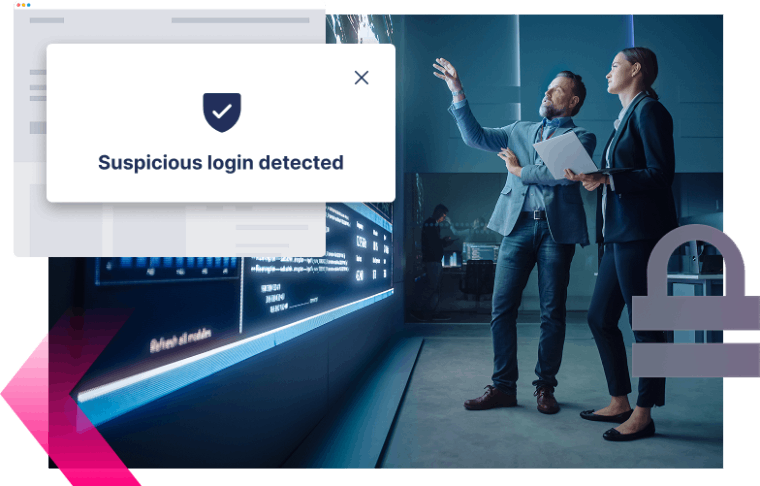 Two people in business attire review data on a large digital screen, discussing a MiTM attack after a notification overlay states "Suspicious login detected.
